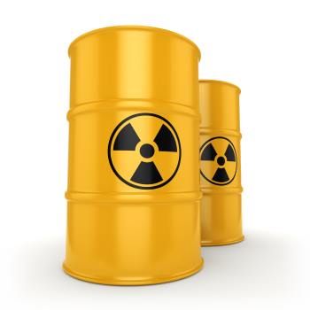Two yellow barrels marked with radiation warnings